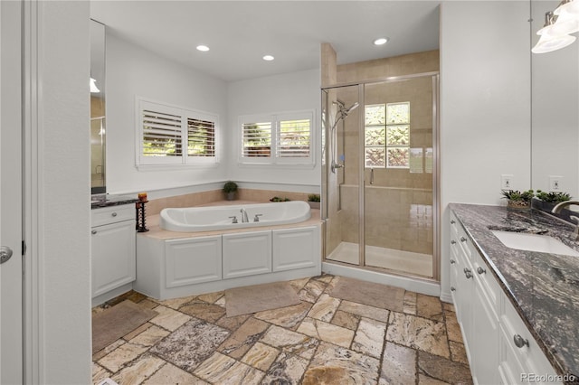 6405 Eagle Feather Trl, Littleton, CO 80125 - full bath with vanity, stone tile flooring, a shower stall, a garden tub, and recessed lighting