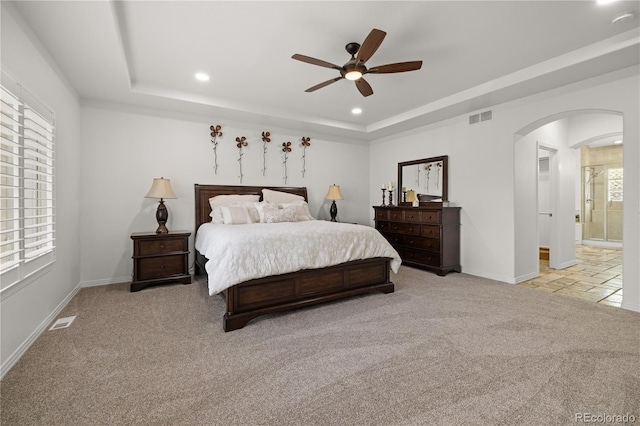 6405 Eagle Feather Trl, Littleton, CO 80125 - bedroom with arched walkways, carpet, a tray ceiling, recessed lighting, and baseboards