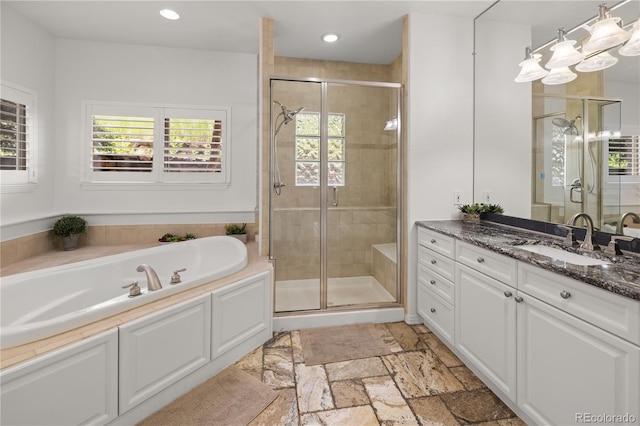 6405 Eagle Feather Trl, Littleton, CO 80125 - full bathroom featuring vanity, a bath, a shower stall, stone tile floors, and recessed lighting