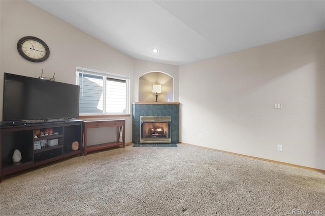 unfurnished living room with a fireplace, carpet floors, and lofted ceiling