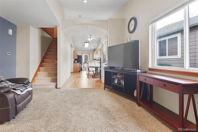 living room with light colored carpet and ceiling fan