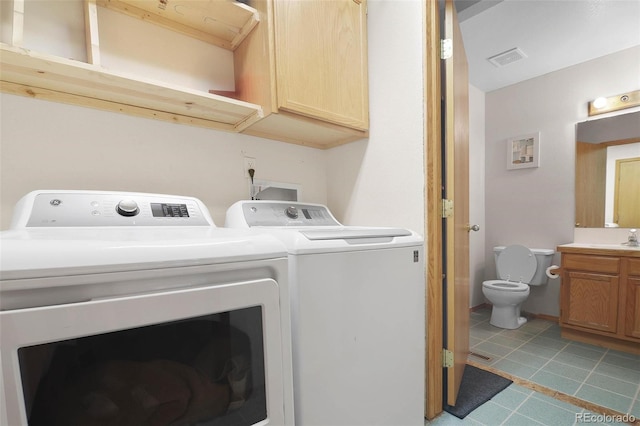 laundry room with washing machine and dryer and sink