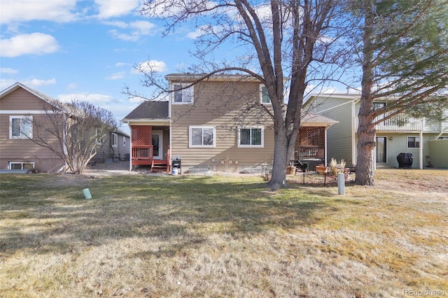 rear view of property with a lawn