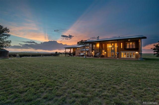 11881 County Road 37, Fort Lupton, CO 80621 - back of property at dusk featuring a lawn