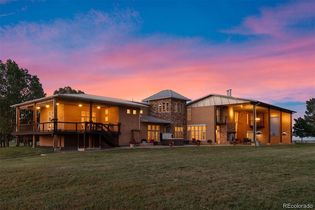 11881 County Road 37, Fort Lupton, CO 80621 - back of house at dusk with a lawn, stairs, and a deck