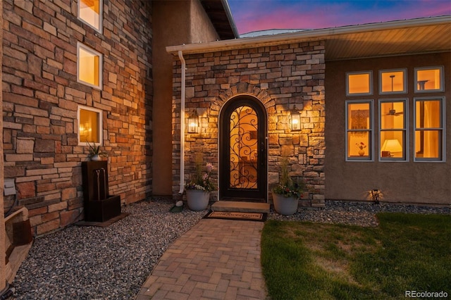 11881 County Road 37, Fort Lupton, CO 80621 - exterior entry at dusk featuring stone siding and stucco siding