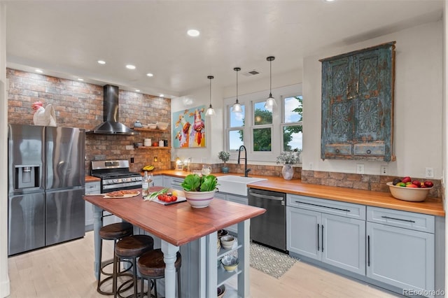 11881 County Road 37, Fort Lupton, CO 80621 - kitchen featuring wooden counters, wall chimney range hood, stainless steel appliances, open shelves, and recessed lighting