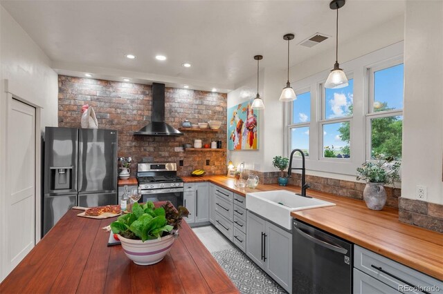 11881 County Road 37, Fort Lupton, CO 80621 - kitchen with butcher block countertops, stainless steel appliances, wall chimney range hood, gray cabinets, and recessed lighting