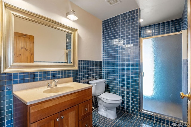 11881 County Road 37, Fort Lupton, CO 80621 - bathroom with tile walls, vanity, a stall shower, and tile patterned floors