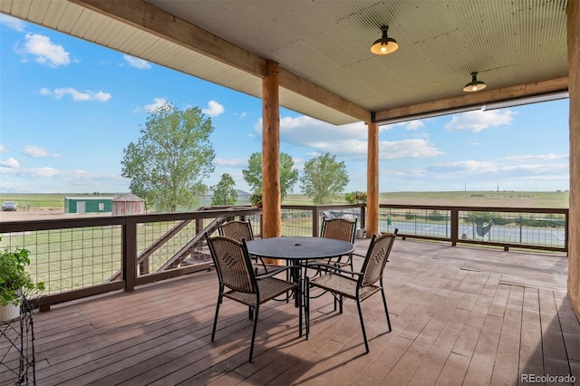 11881 County Road 37, Fort Lupton, CO 80621 - wooden terrace with outdoor dining space and a water view