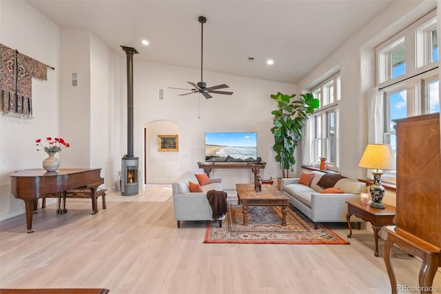 11881 County Road 37, Fort Lupton, CO 80621 - living room with a wood stove, a ceiling fan, light wood-type flooring, recessed lighting, and a high ceiling