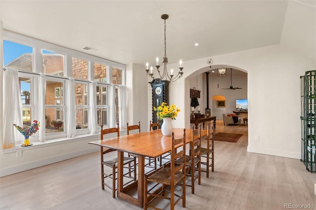 11881 County Road 37, Fort Lupton, CO 80621 - dining space with light wood finished floors, arched walkways, and a chandelier