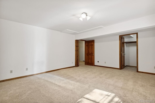 unfurnished bedroom with a spacious closet, a closet, and light colored carpet