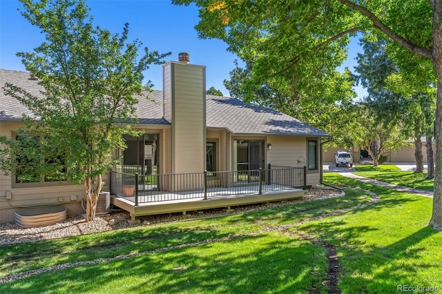 back of property with cooling unit, a yard, and a wooden deck