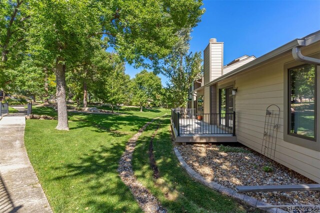 view of yard with a wooden deck