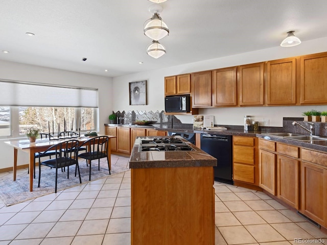 kitchen featuring a center island, light tile patterned floors, brown cabinets, black appliances, and a sink