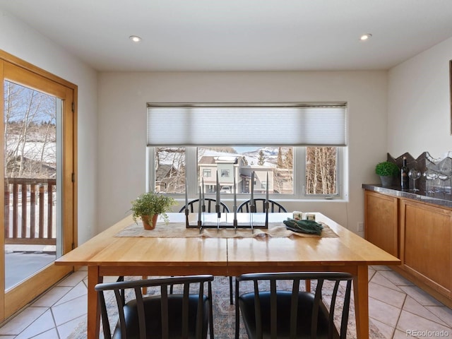 dining area with plenty of natural light, light tile patterned flooring, and recessed lighting