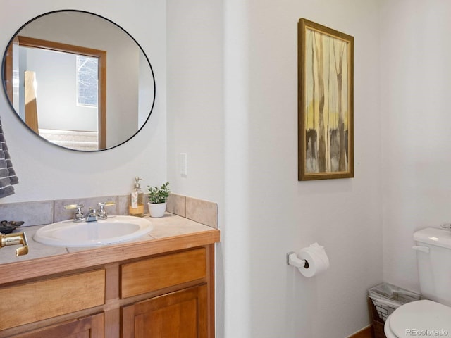 bathroom featuring toilet and vanity