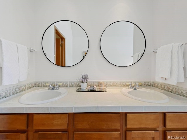 bathroom featuring a sink and double vanity