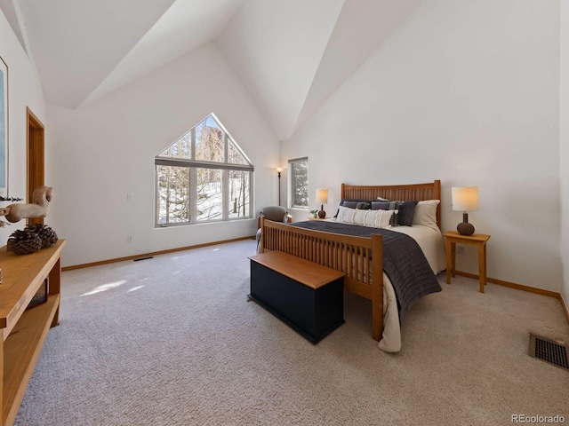 carpeted bedroom featuring visible vents, baseboards, and high vaulted ceiling