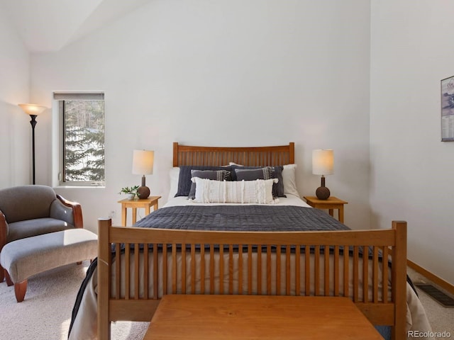 bedroom featuring lofted ceiling, carpet flooring, baseboards, and visible vents