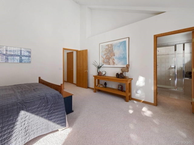 carpeted bedroom with high vaulted ceiling and baseboards