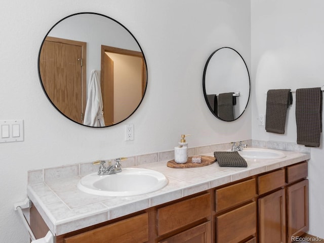 full bathroom featuring double vanity and a sink