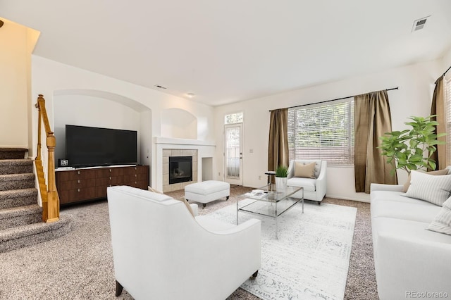 371 Granby Way Unit C, Aurora, CO 80011 - living room with stairs, a tiled fireplace, and light carpet
