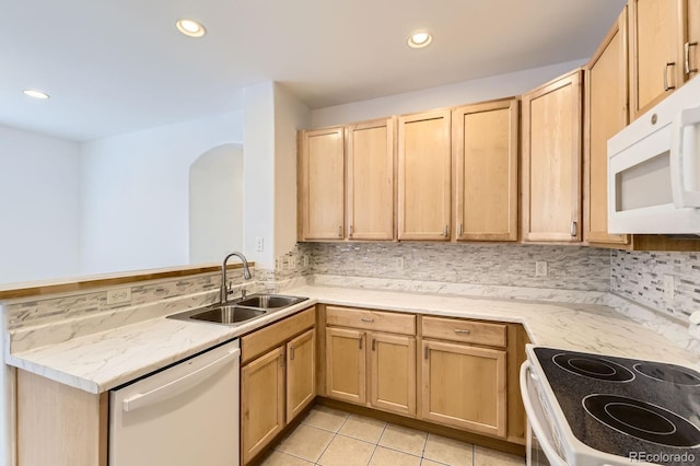 371 Granby Way Unit C, Aurora, CO 80011 - kitchen with white appliances, a sink, light brown cabinetry, tasteful backsplash, and light stone counters