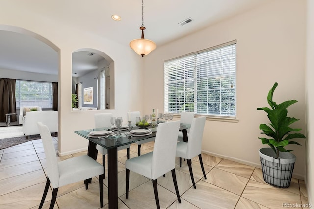 371 Granby Way Unit C, Aurora, CO 80011 - dining space featuring arched walkways, recessed lighting, light tile patterned floors, and baseboards