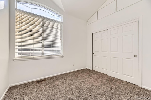 371 Granby Way Unit C, Aurora, CO 80011 - unfurnished bedroom featuring carpet, lofted ceiling, a closet, and baseboards