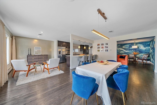 dining room with dark hardwood / wood-style floors and baseboard heating