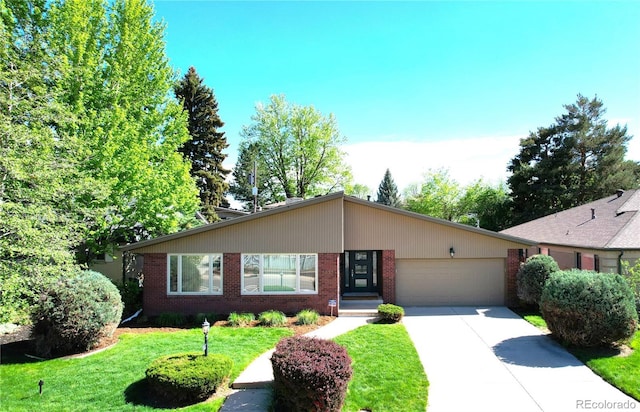 6630 E Virginia Ave, Denver, CO 80224 - view of front of home featuring a garage, driveway, brick siding, and a front lawn