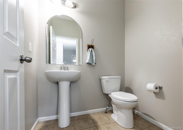 bathroom featuring tile patterned flooring and toilet