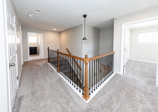 hall featuring light colored carpet