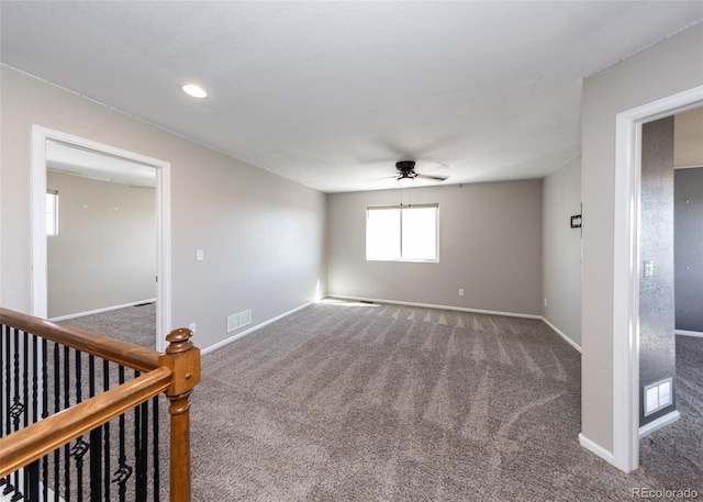 spare room with carpet and ceiling fan