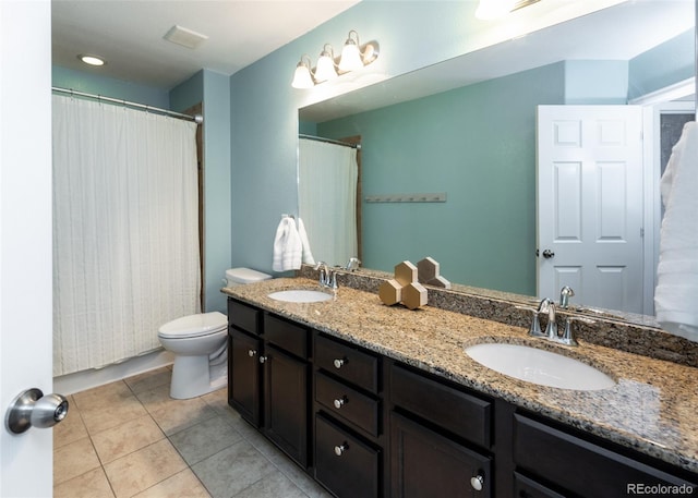 bathroom featuring curtained shower, tile patterned flooring, vanity, and toilet