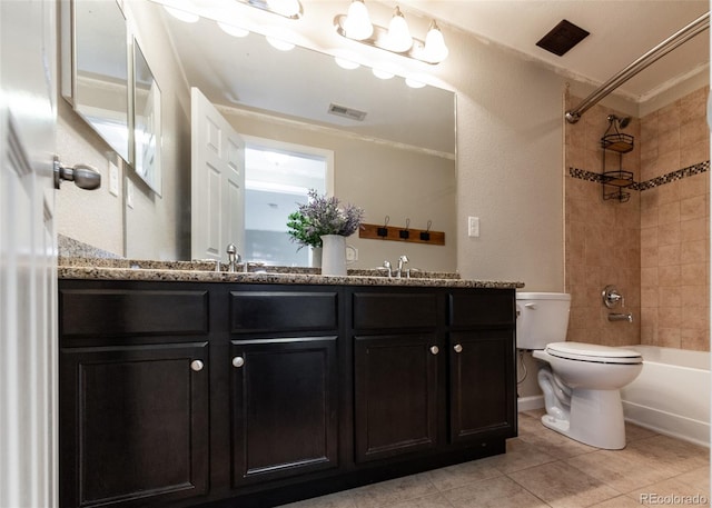 full bathroom with vanity, tiled shower / bath combo, tile patterned floors, crown molding, and toilet