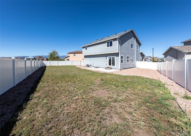 back of property featuring a patio and a yard