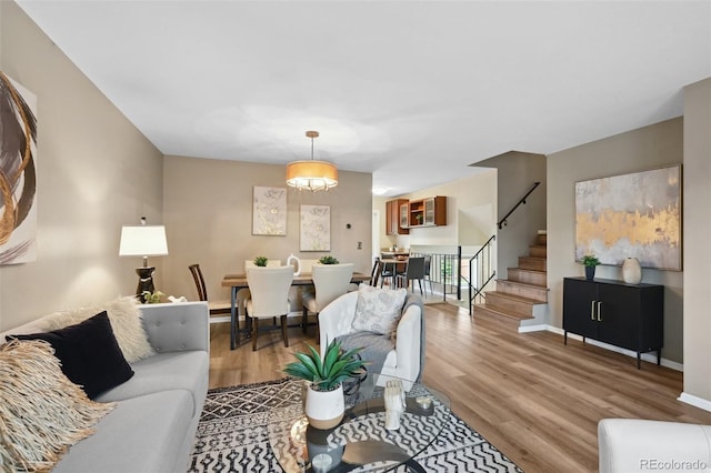 9306 Garrison Dr, Broomfield, CO 80021 - living area featuring stairs, wood finished floors, and baseboards