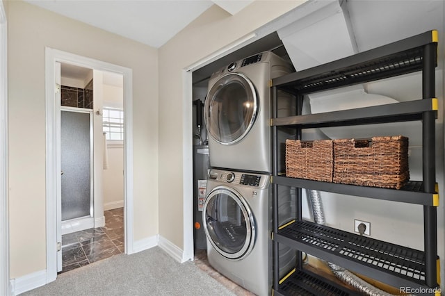 9306 Garrison Dr, Broomfield, CO 80021 - laundry area featuring stacked washer / drying machine, baseboards, marble finish floors, and water heater