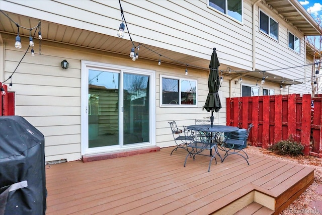 wooden deck featuring fence, area for grilling, and outdoor dining space