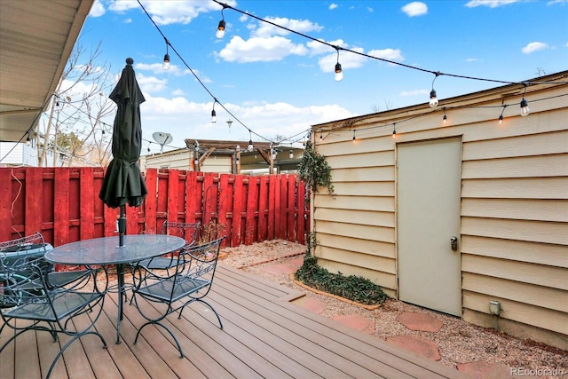 wooden deck featuring fence and outdoor dining space