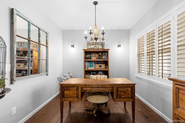 office space with an inviting chandelier and dark wood-type flooring