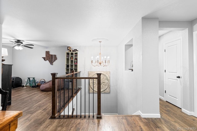 corridor with a chandelier and dark hardwood / wood-style floors