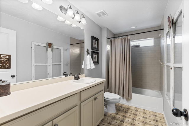 full bathroom featuring toilet, vanity, and shower / tub combo with curtain