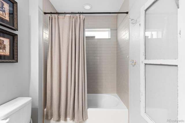 bathroom featuring toilet and shower / bathtub combination with curtain