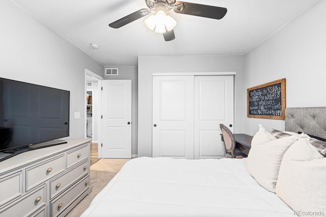 carpeted bedroom featuring ceiling fan and a closet