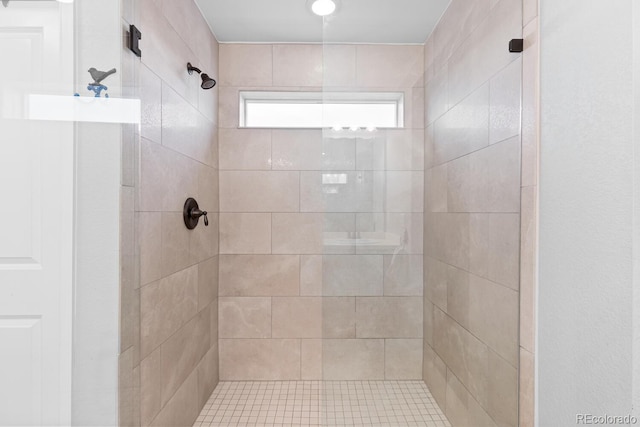 bathroom with a tile shower