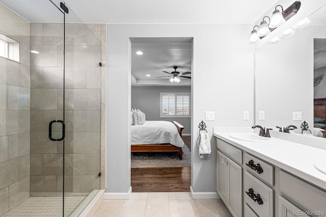 bathroom with hardwood / wood-style flooring, ceiling fan, a shower with shower door, and vanity